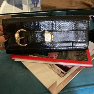 Gucci snakeskin clutch with gold accents